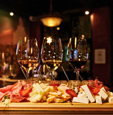 Greek wine and food pairing in Athens with wine glasses, cheeses and charcuterie