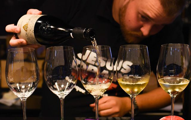 Sommelier pouring Greek wine into tasting glasses during a wine tasting in Athens